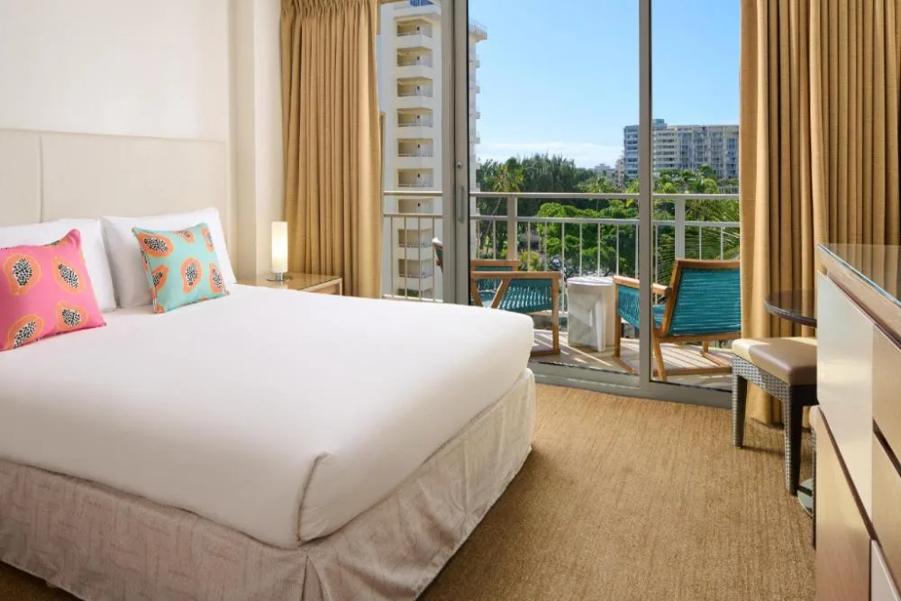 Classic guest room with king bed and balcony at Kaimana Beach Hotel.
