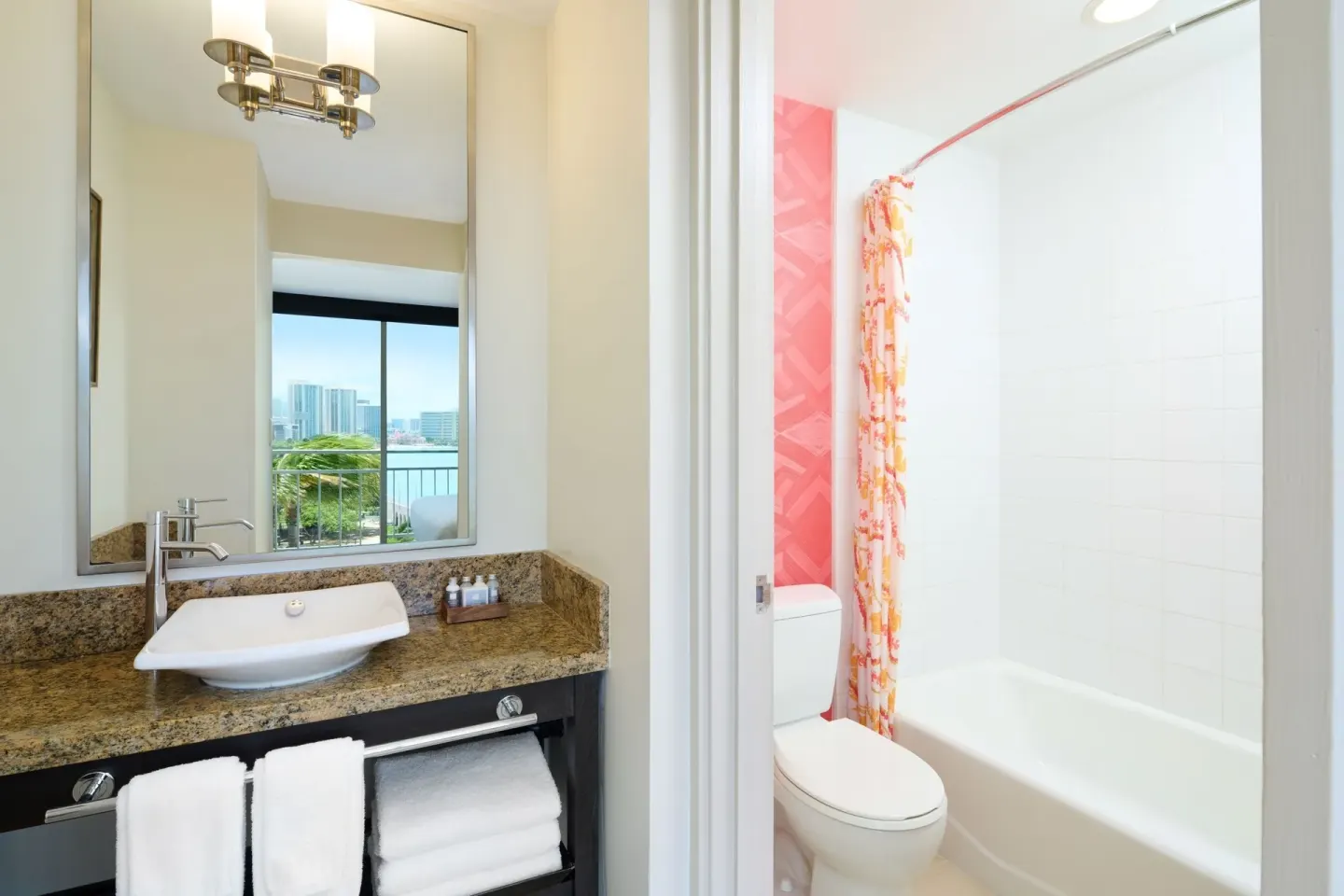 Ocean View room bathroom vanity and tub with room view reflected at Kaimana Beach Hotel.