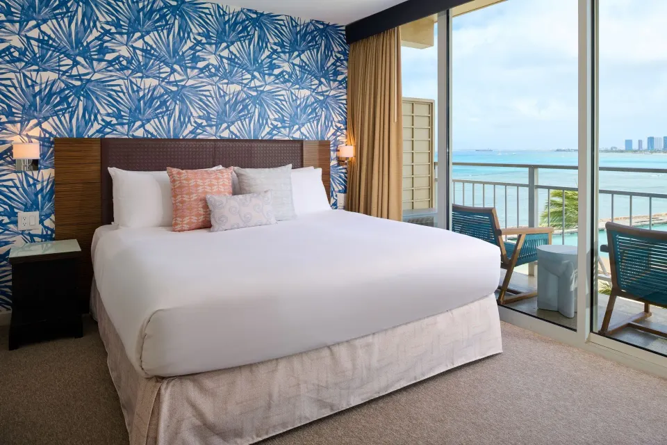 Ocean View room with king bed and balcony facing the water at Kaimana Beach Hotel.
