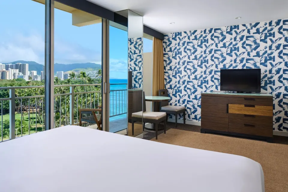 Ocean View room with king bed, seating, TV, and balcony views at Kaimana Beach Hotel.