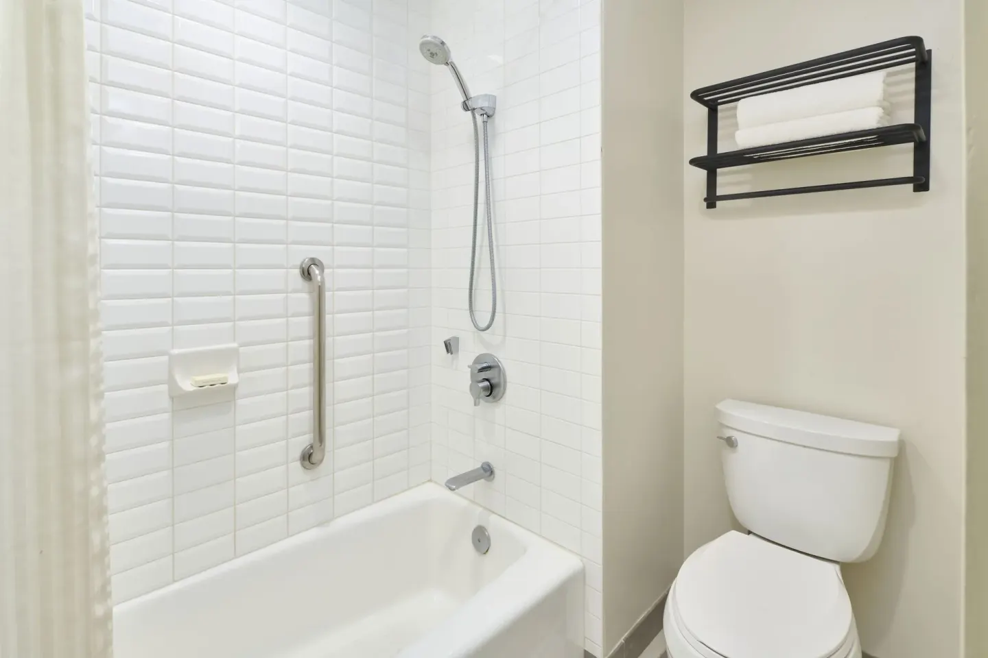 Park View room bathroom with tub-shower and toilet at Kaimana Beach Hotel.
