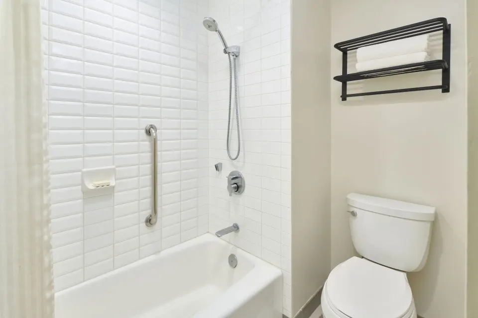 Park View room bathroom with tub-shower and toilet at Kaimana Beach Hotel.