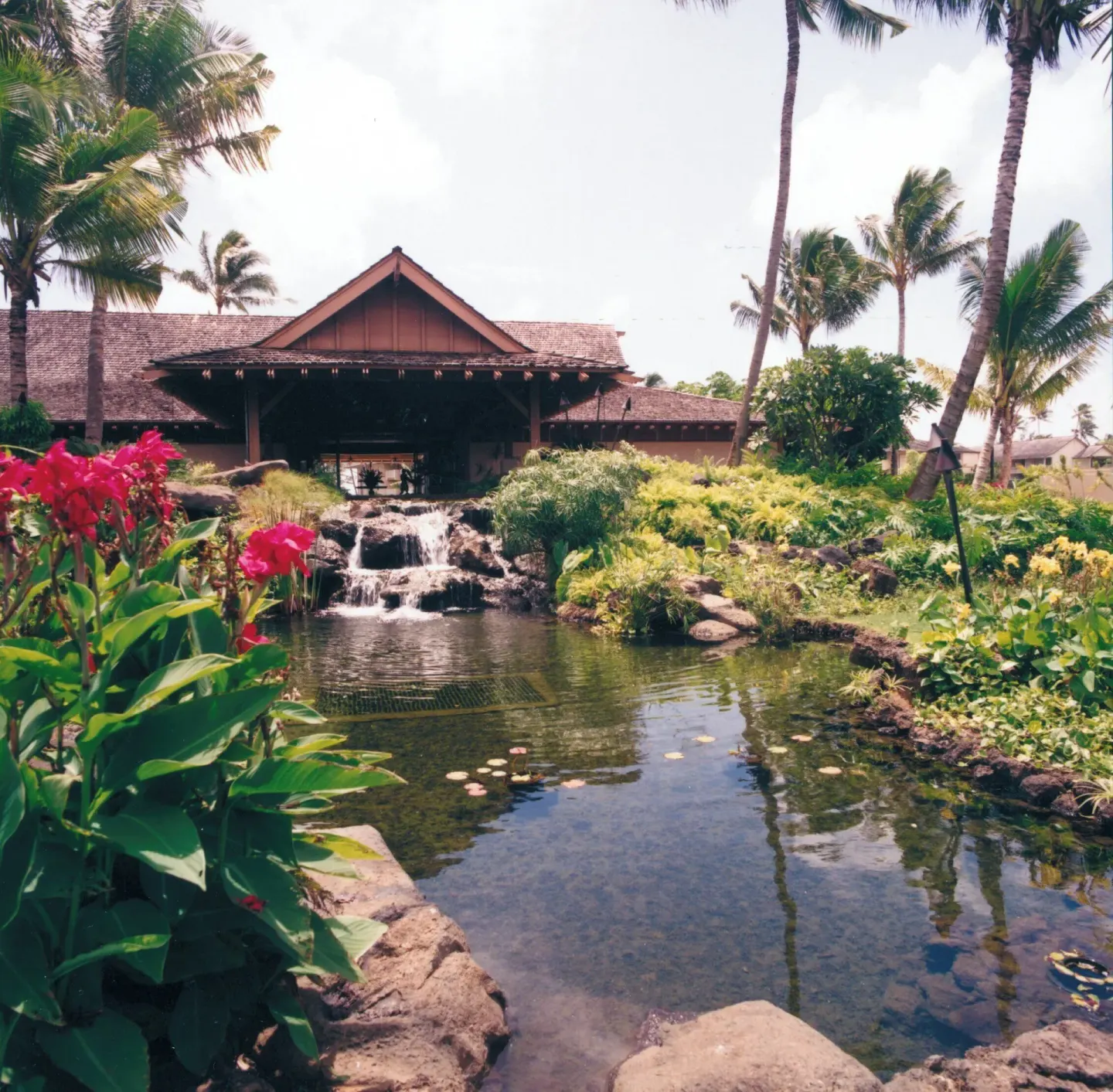 Pond, waterfall, and pavilion-style building at Kauai Coast at the Beachboy.