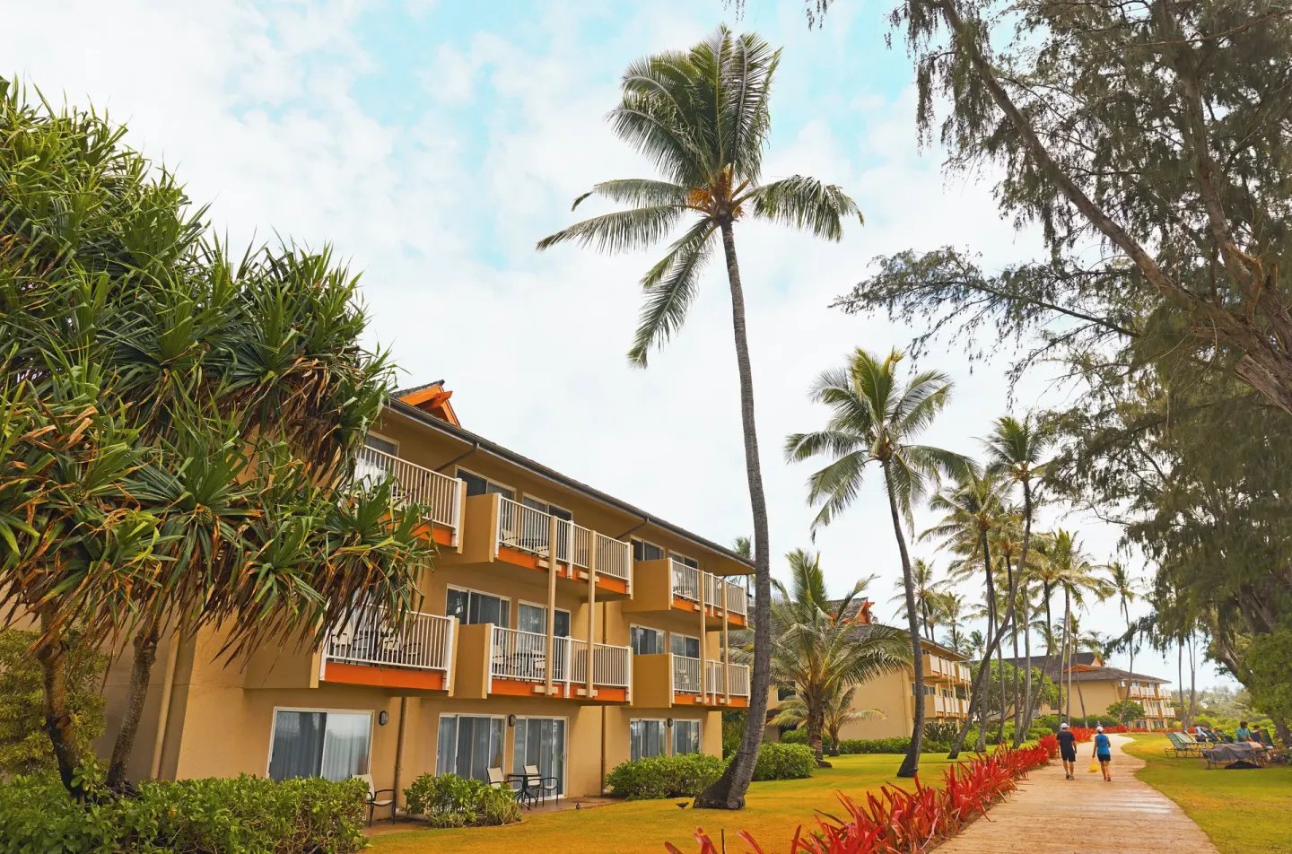 Guestroom balconies and palm-lined walkway at Kauai Coast at the Beachboy.