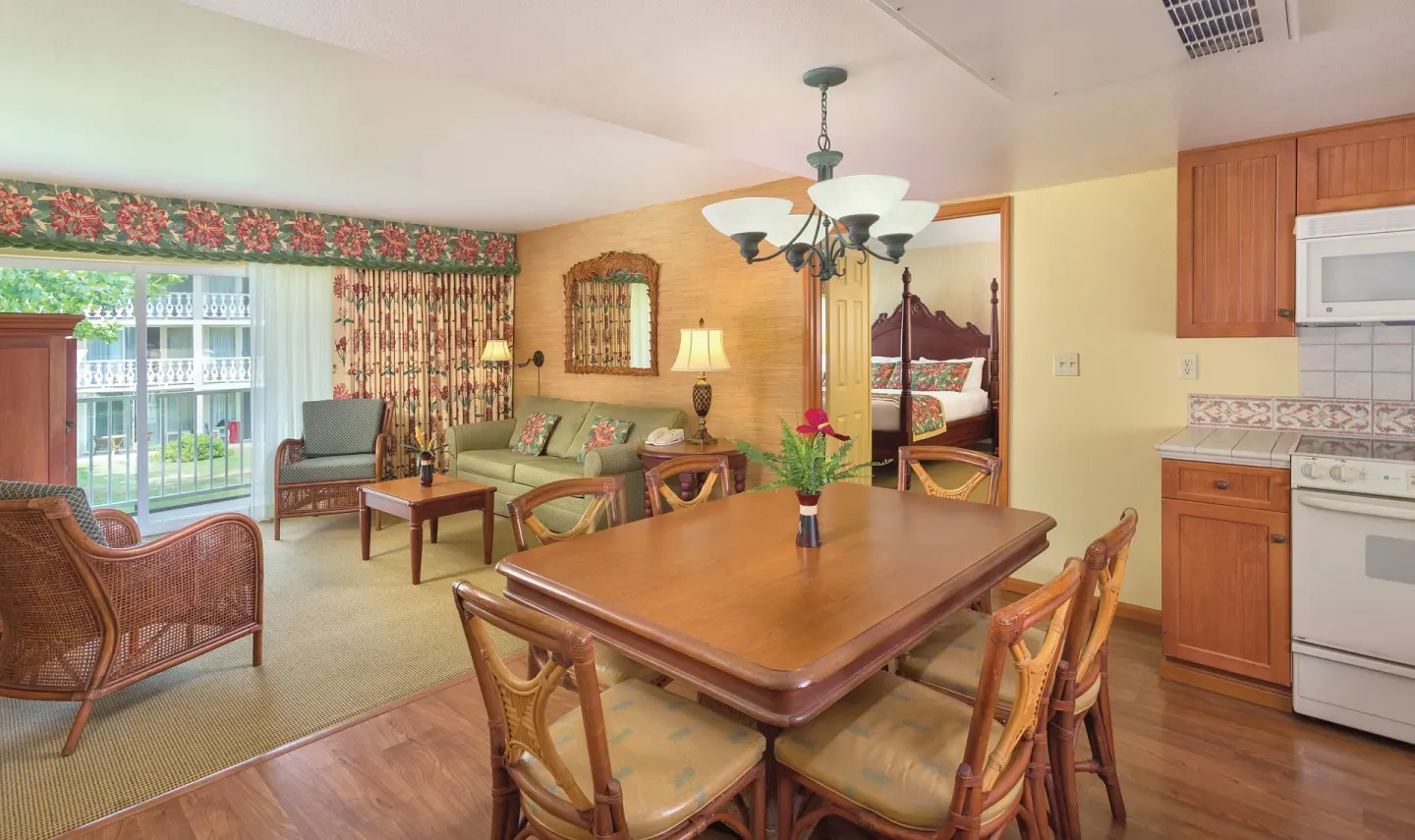 Suite dining, kitchen, living area, and king bed at Kauai Coast at the Beachboy.