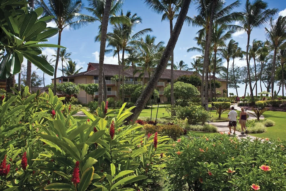 Tropical garden walkway and resort buildings at Kauai Coast at the Beachboy.