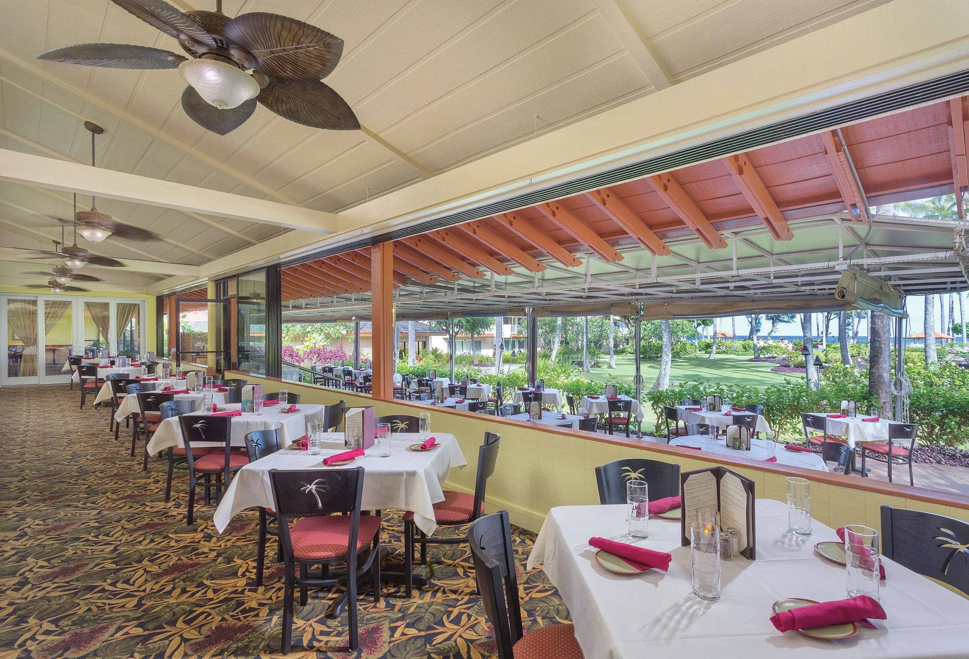 Open-air dining room with garden views at Kauai Coast at the Beachboy.