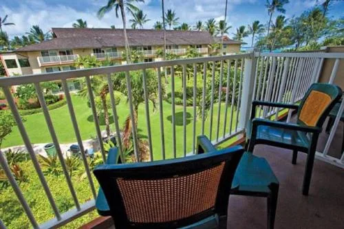 Garden-view villa balcony with chairs at Kauai Coast at the Beachboy.