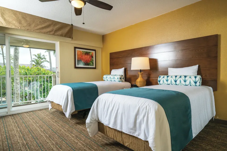 Two beds in the accessible ohana suite bedroom at Kauai Coast at the Beachboy.