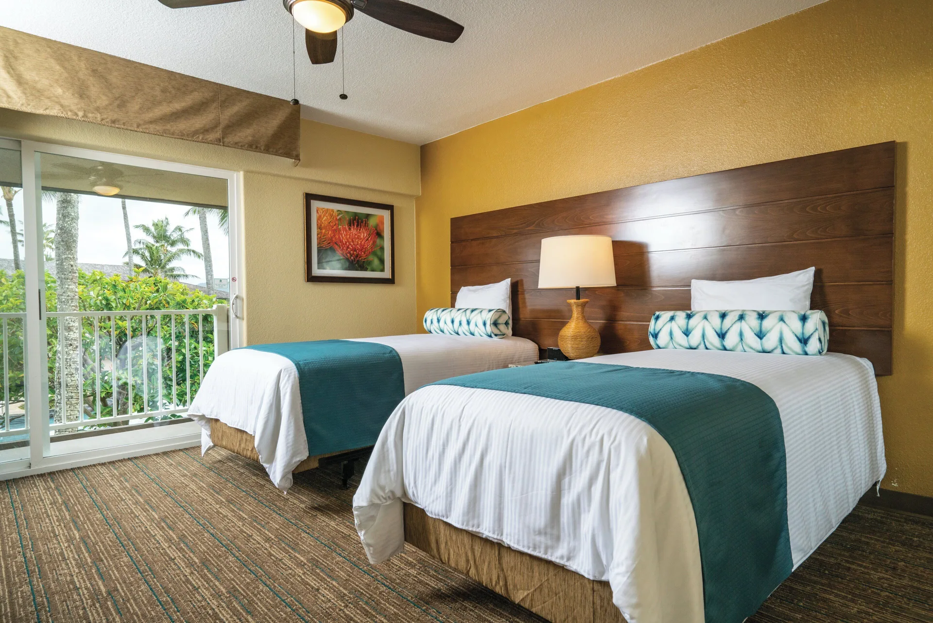 Two beds in the accessible ohana suite bedroom at Kauai Coast at the Beachboy.