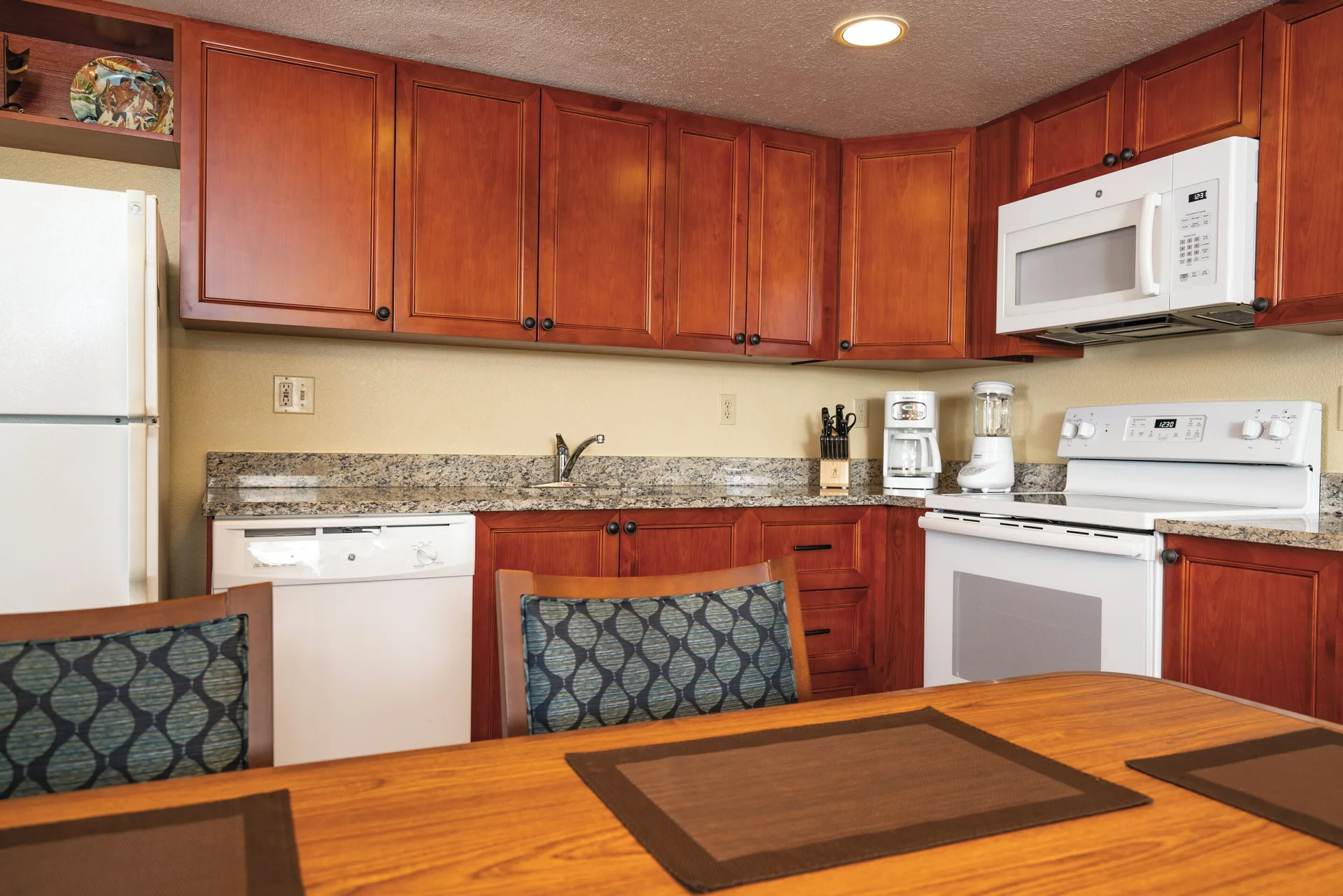 Accessible one-bedroom villa kitchen with dining table at Kauai Coast at the Beachboy.