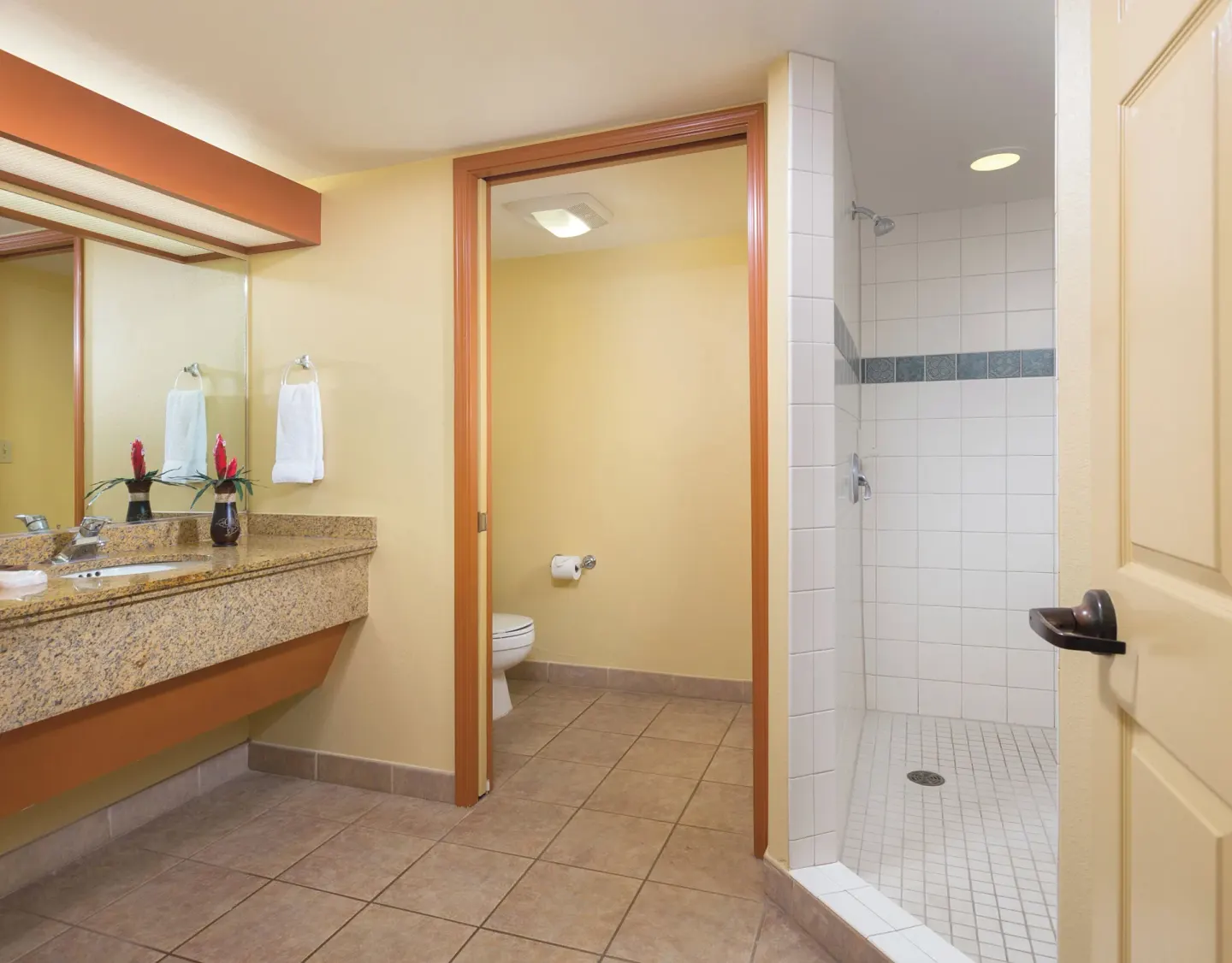 One-bedroom garden view villa bathroom with vanity and shower at Kauai Coast at the Beachboy.