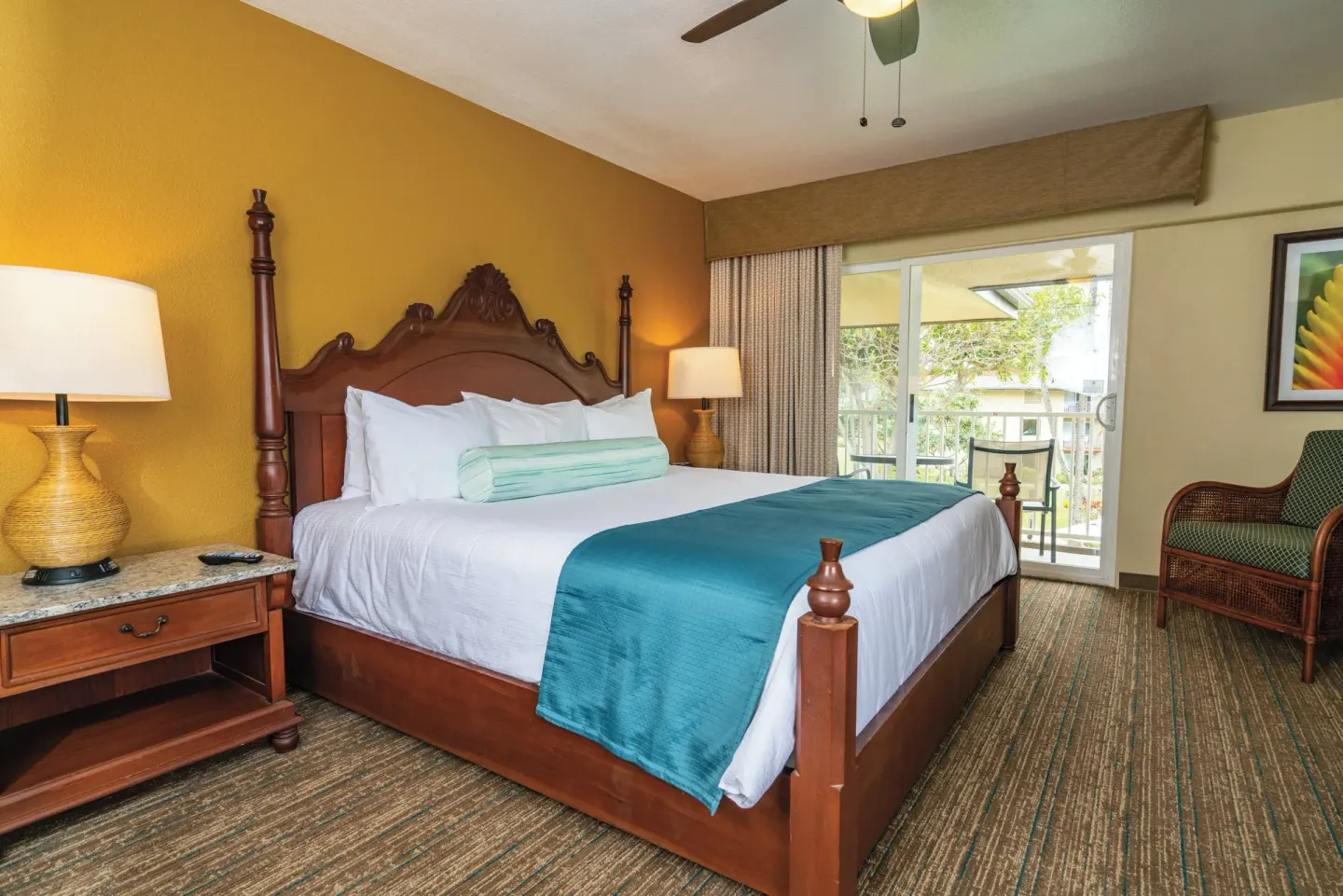One-bedroom garden view villa bedroom with four-poster bed at Kauai Coast at the Beachboy.