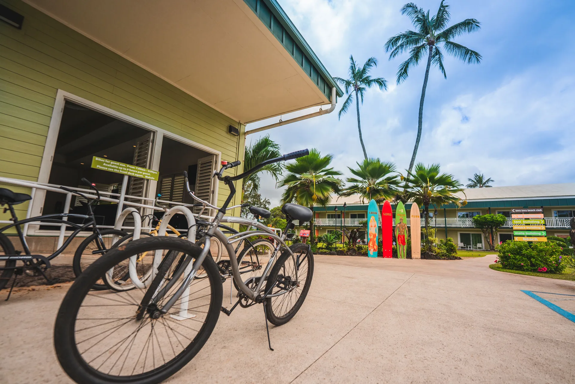 Bicycle racks, palm trees, and resort buildings at Kauai Shores Hotel.