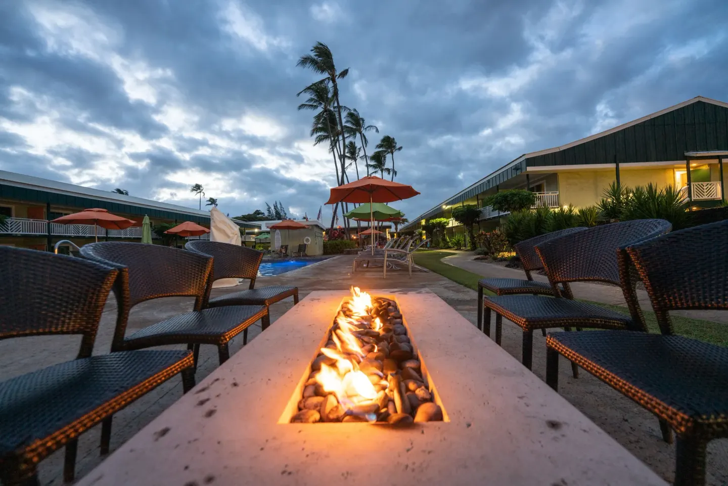 Fire pit seating near the pool courtyard at Kauai Shores Hotel.