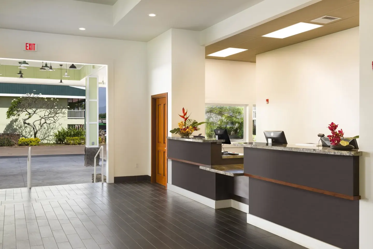 Reception desks in the bright lobby at Kauai Shores Hotel.