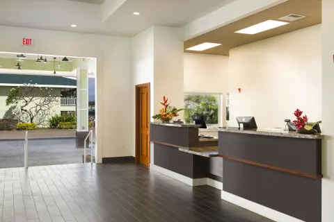Reception desks in the bright lobby at Kauai Shores Hotel.
