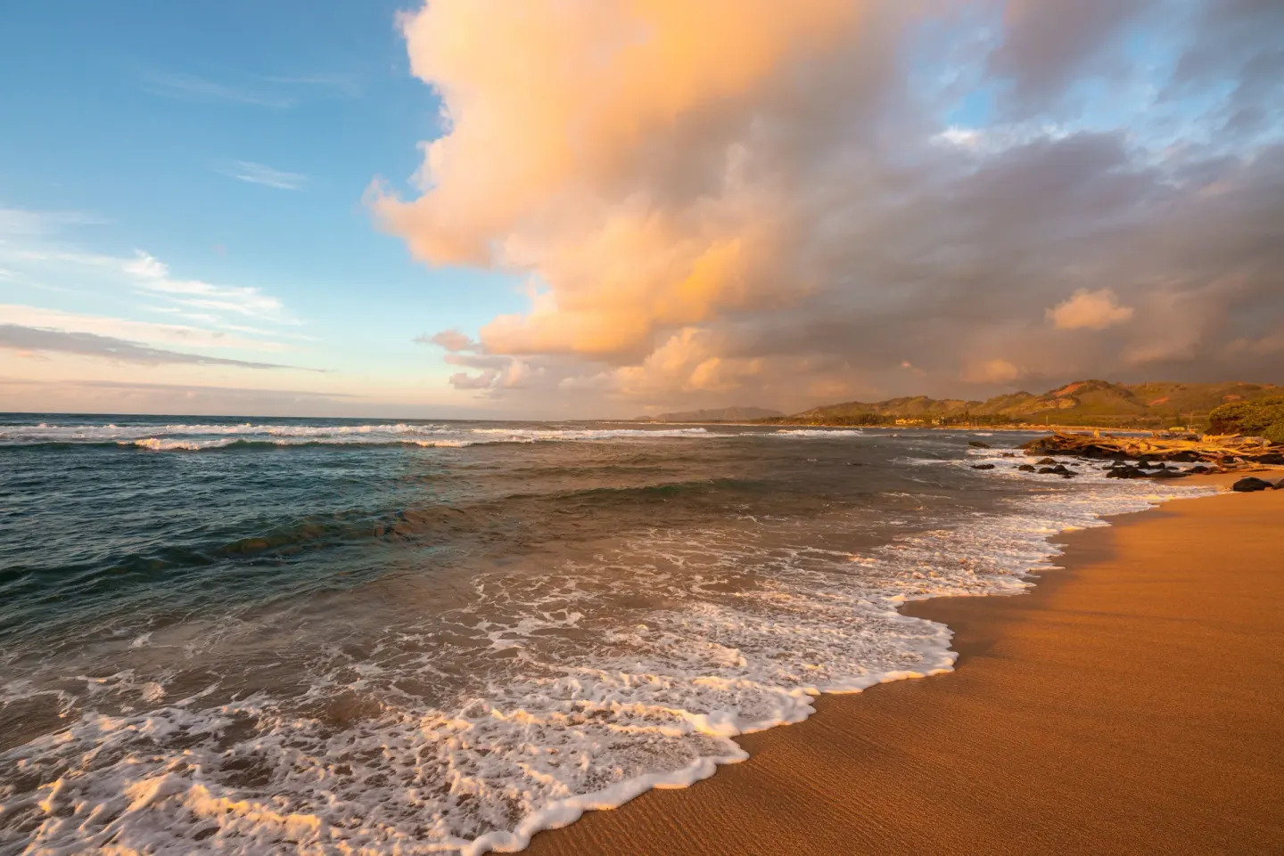 Ocean waves and golden clouds on the beach at Kauai Shores Hotel.