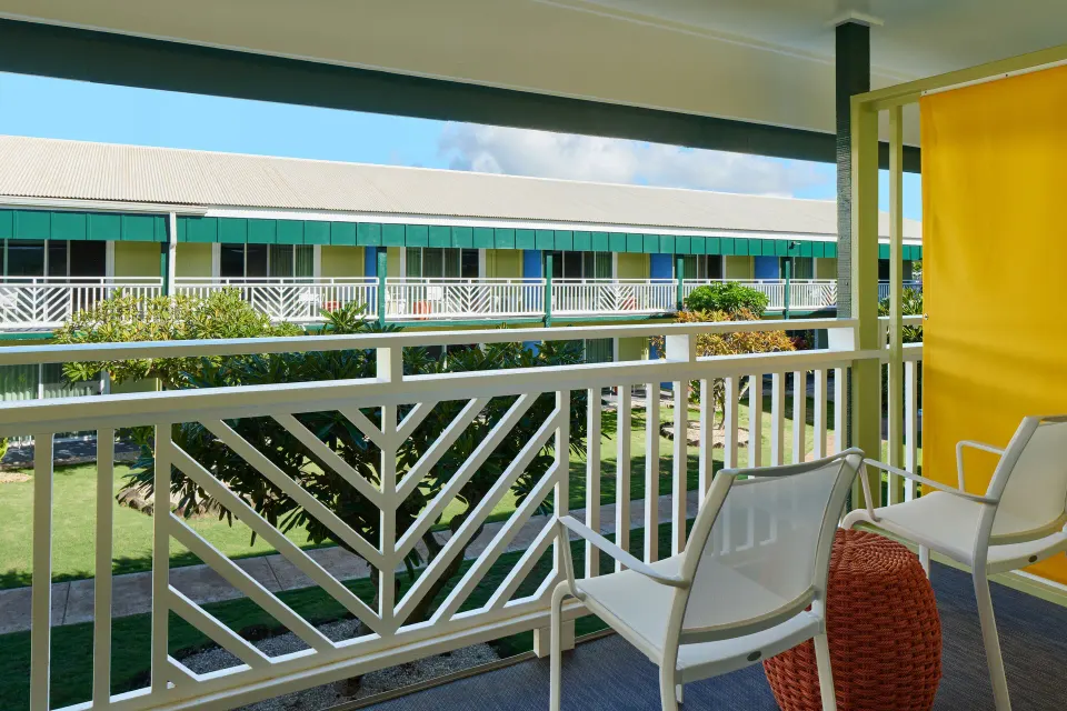 Garden View room balcony with chairs overlooking hotel gardens at Kauai Shores Hotel.