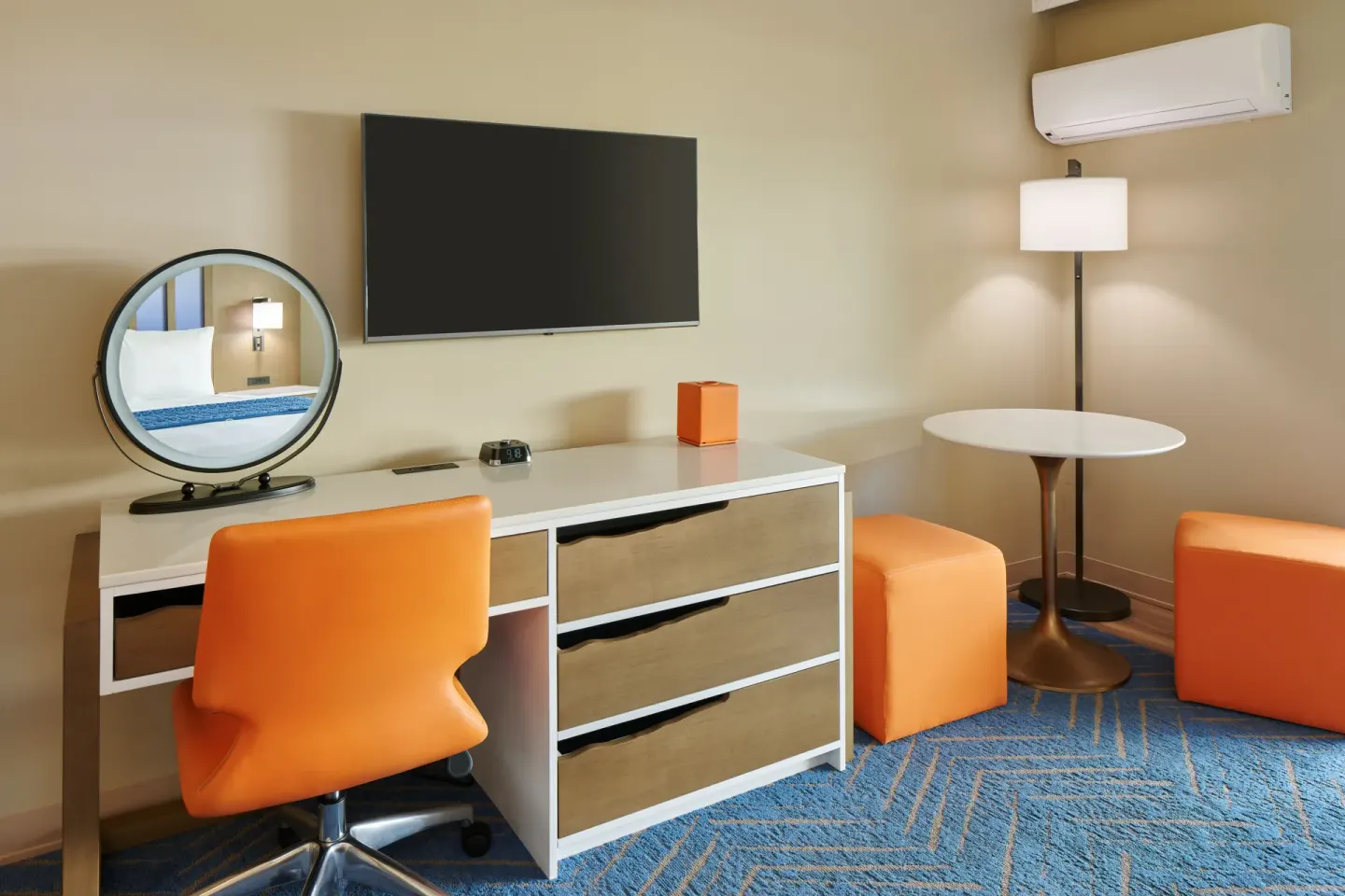 Garden View room desk, dresser, TV, and seating at Kauai Shores Hotel.