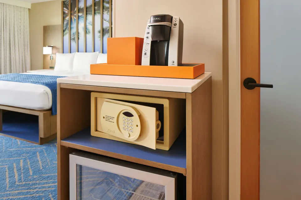 Garden View room refreshment nook with safe and mini fridge at Kauai Shores Hotel.