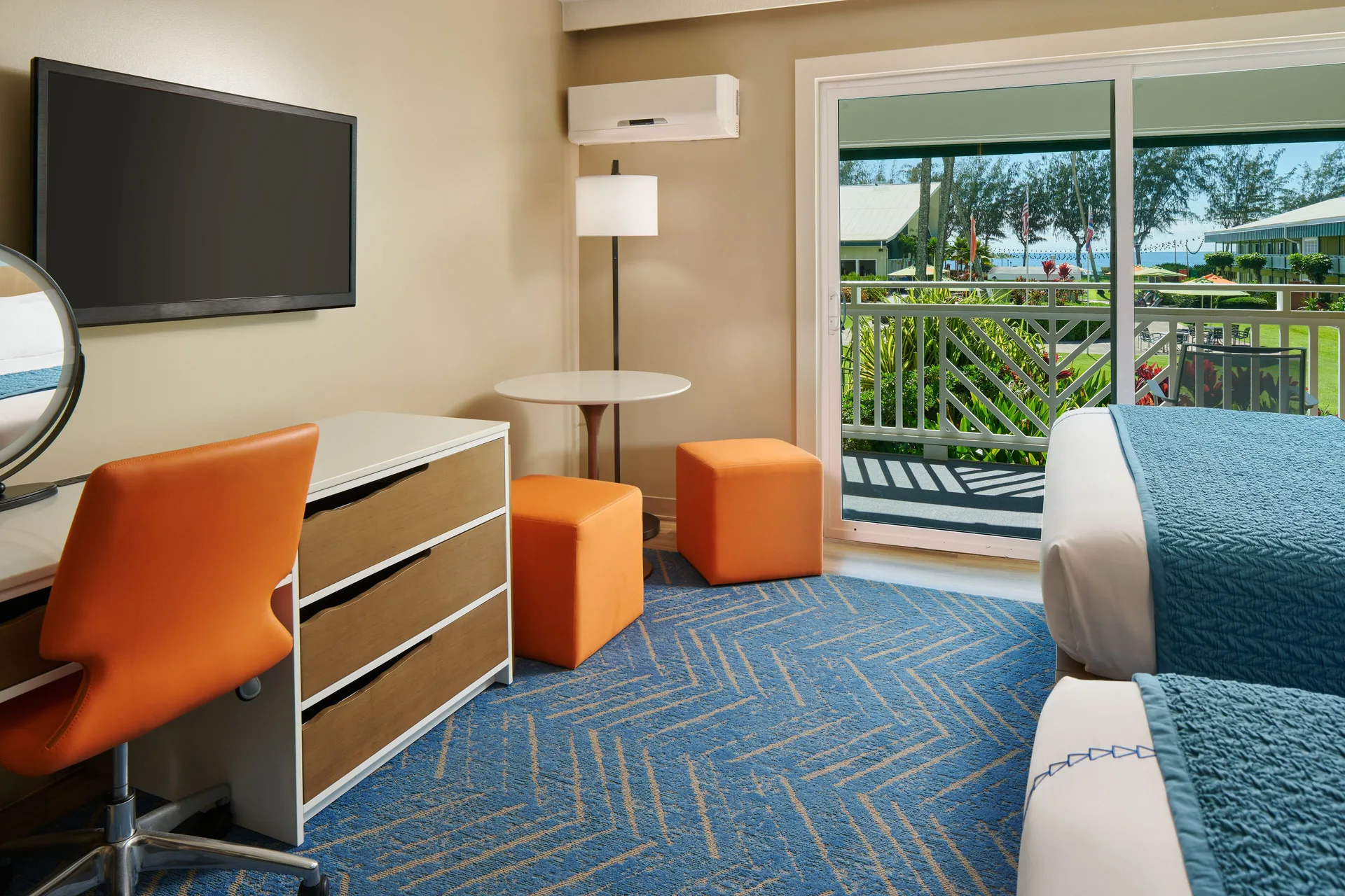 Ocean View room at Kauai Shores Hotel with desk, TV, balcony, and two beds partly visible.