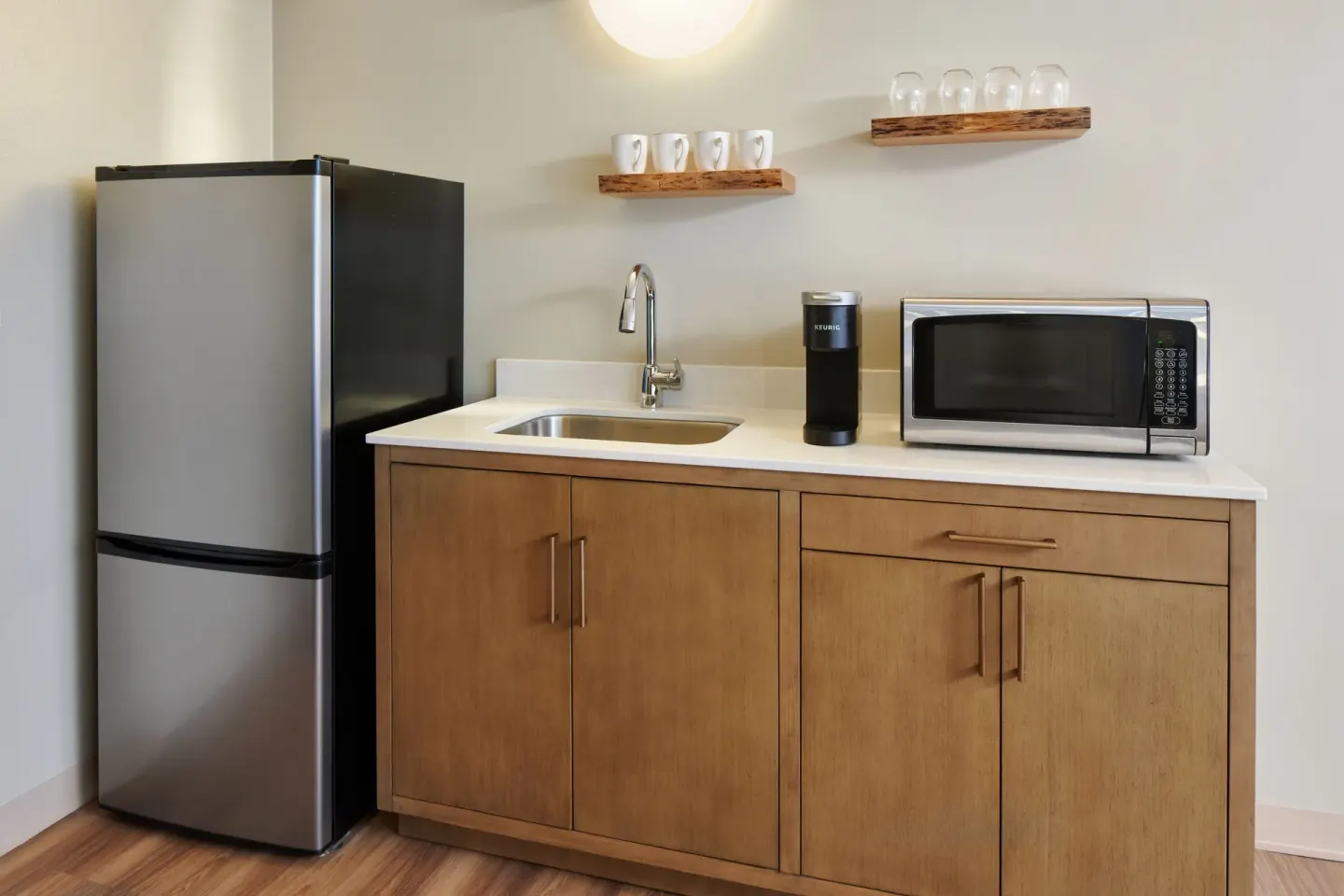 Studio kitchenette with refrigerator, sink, coffee maker, and microwave at Kauai Shores Hotel.