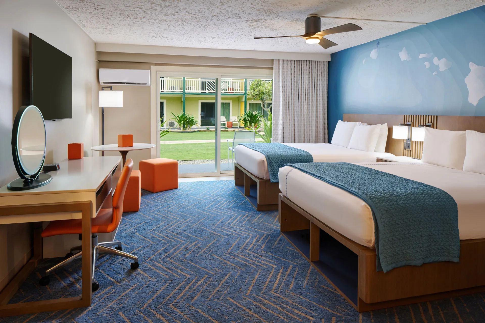 Newly renovated studio with two beds and patio view at Kauai Shores Hotel.
