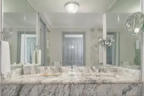 Marble double vanity bathroom with mirrors at Kempinski Hotel Cancún.