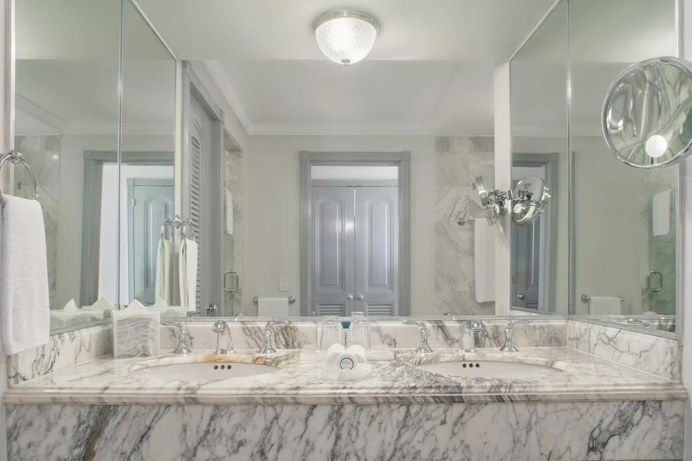 Marble double vanity bathroom with mirrors at Kempinski Hotel Cancún.