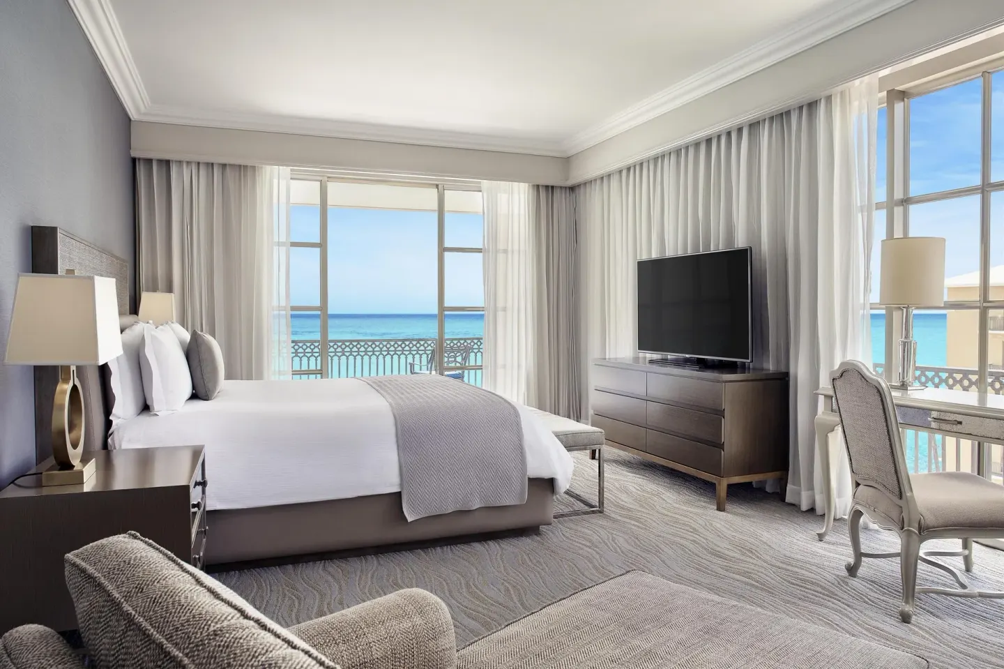 Ocean-view guest room with a king bed and balcony at Kempinski Hotel Cancún.