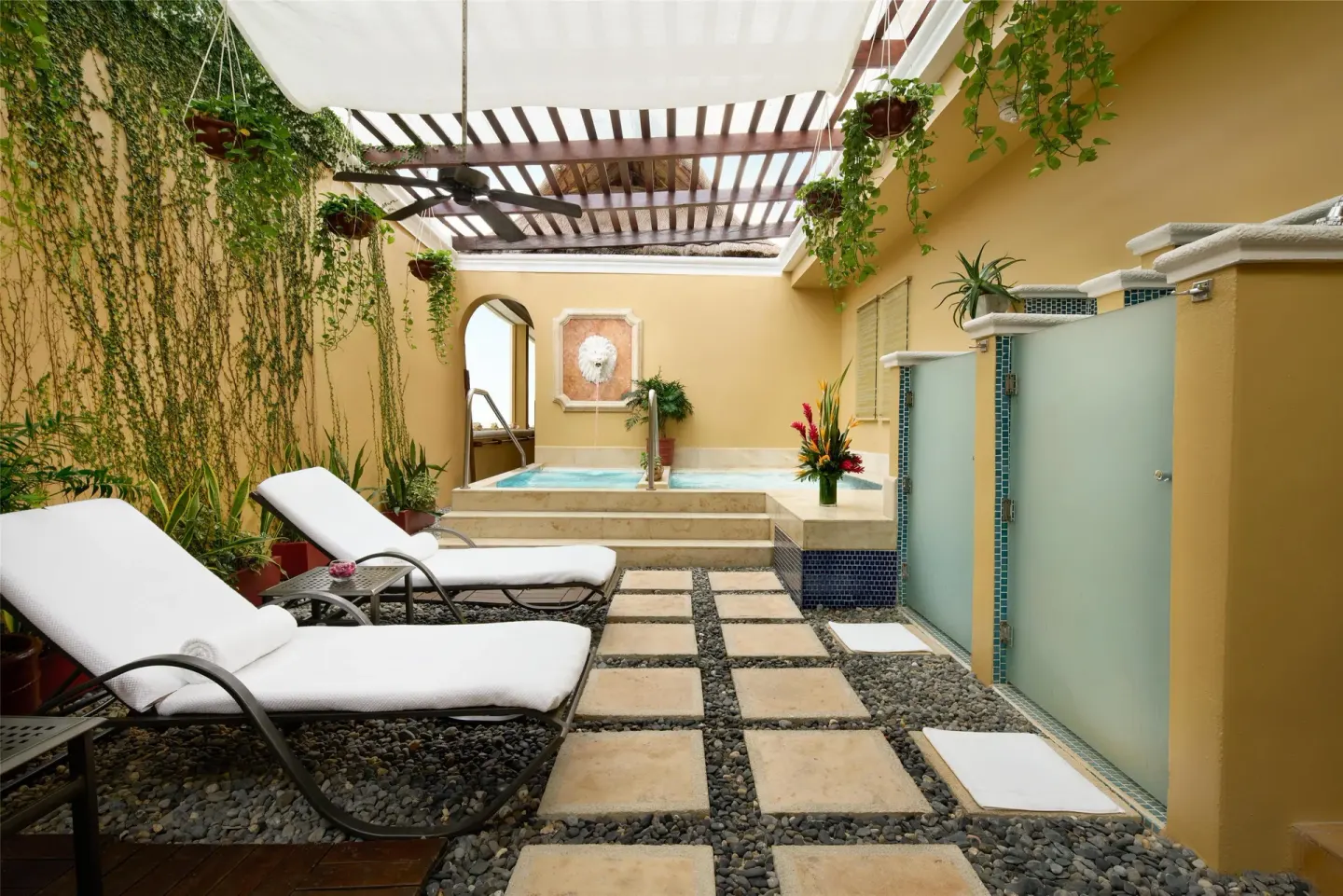Private terrace with loungers, plants and plunge pool at Kempinski Hotel Cancún.