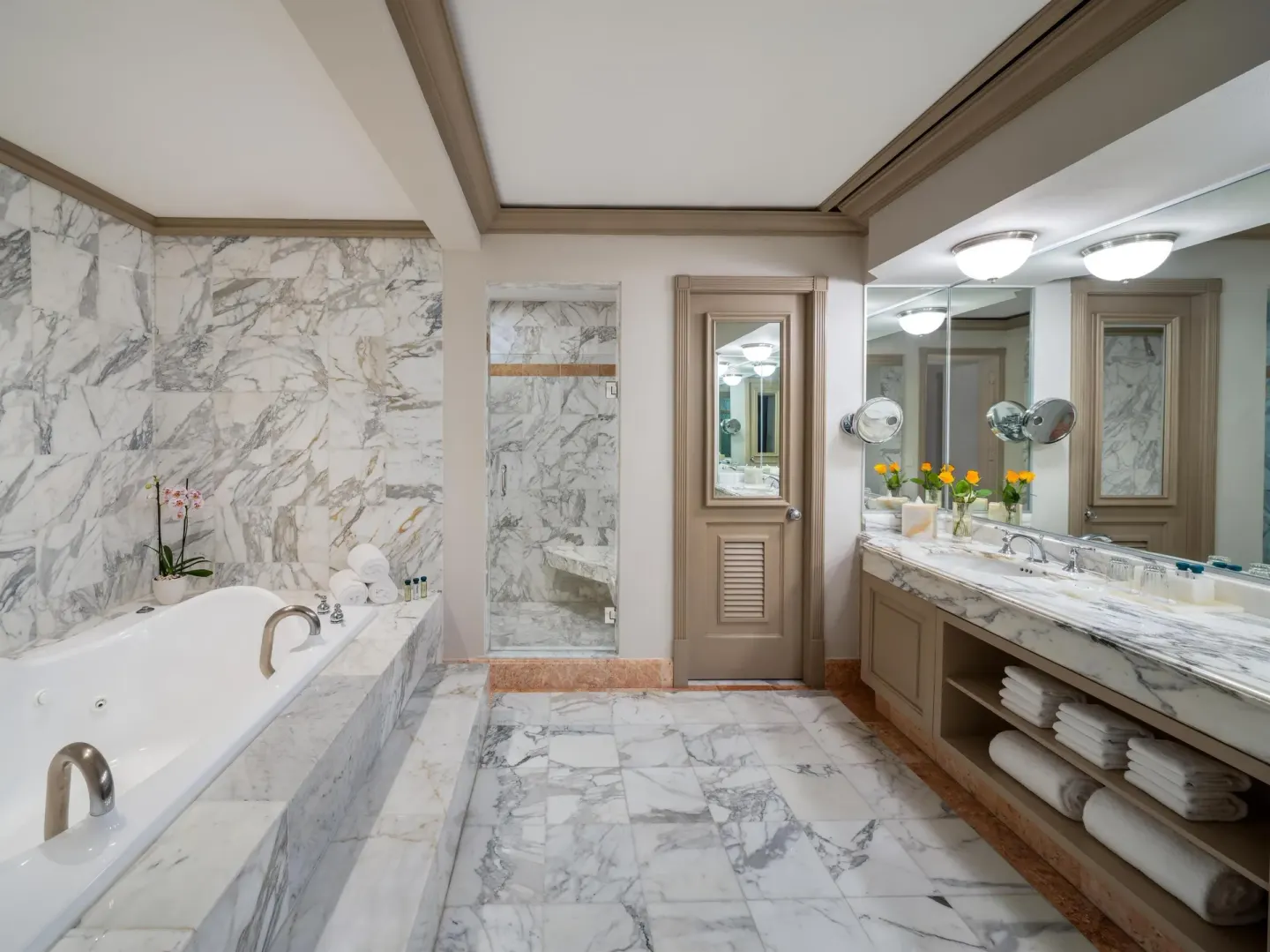 Spacious marble bathroom with soaking tub and double vanity at Kempinski Hotel Cancún.