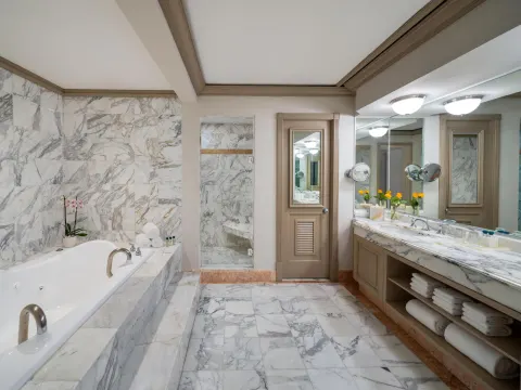 Spacious marble bathroom with soaking tub and double vanity at Kempinski Hotel Cancún.