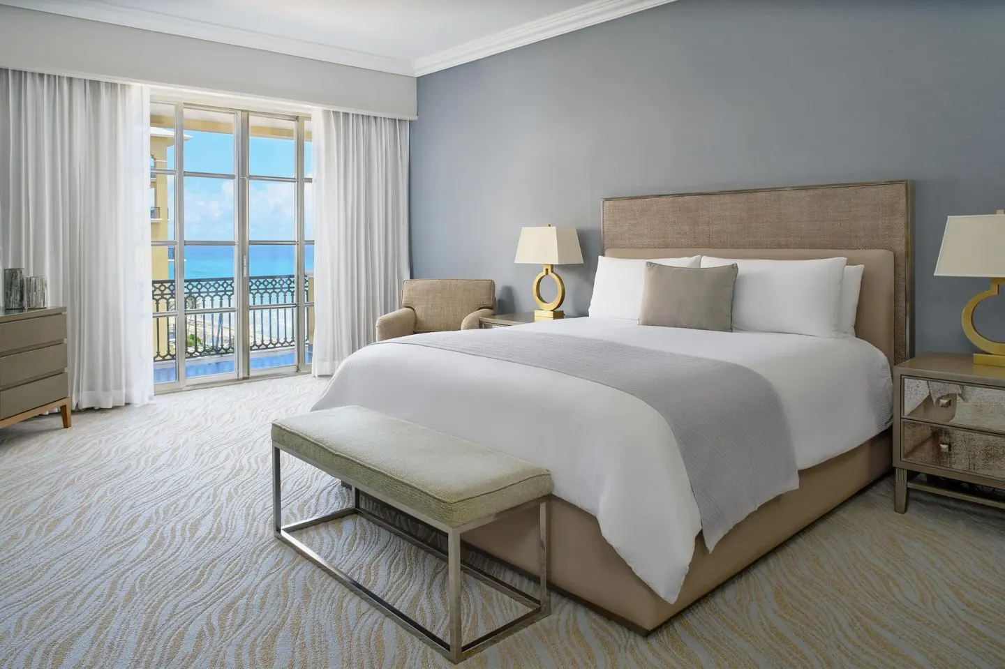 Club Suite seaside bedroom with king bed and balcony at Kempinski Hotel Cancún.