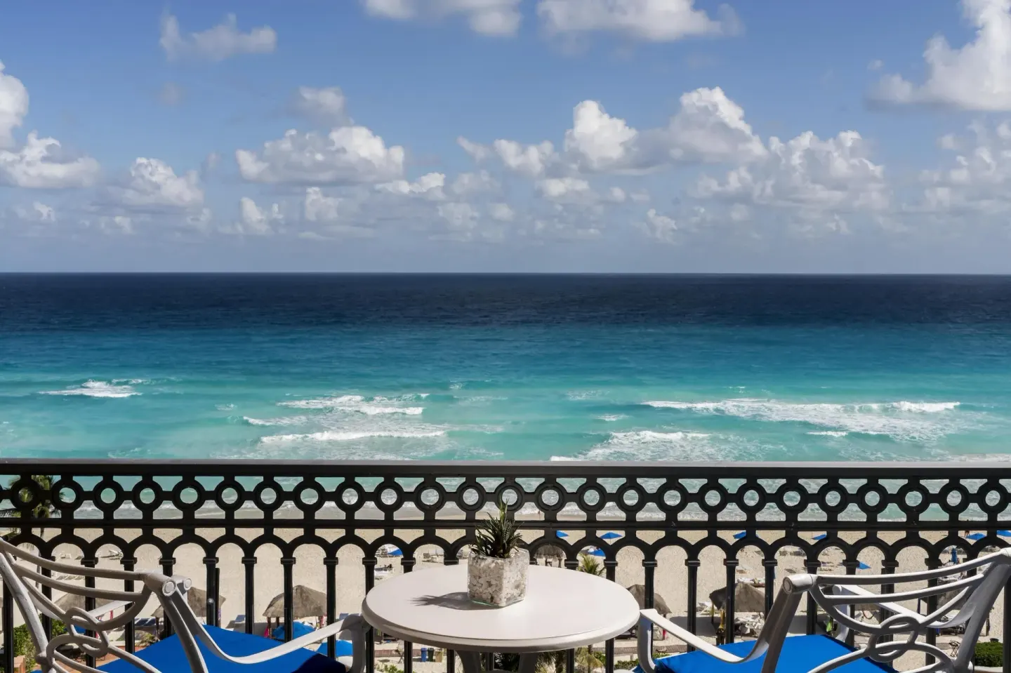 Seafront balcony with chairs and Caribbean water at Kempinski Hotel Cancún.