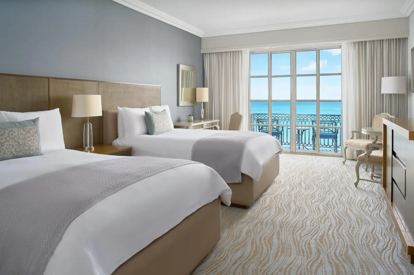 Deluxe seafront room with two beds and balcony view at Kempinski Hotel Cancún.