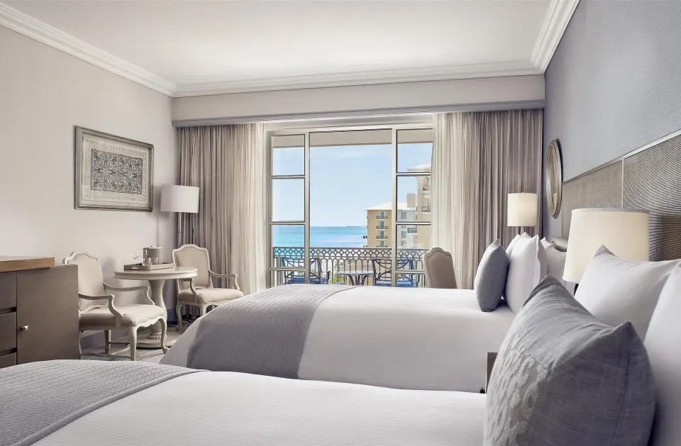 Deluxe seaside room with two beds, balcony, and ocean view at Kempinski Hotel Cancún.