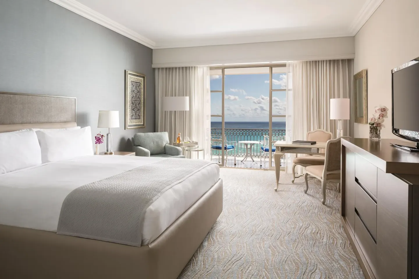 Deluxe seaside room with king bed and ocean-facing balcony at Kempinski Hotel Cancún.