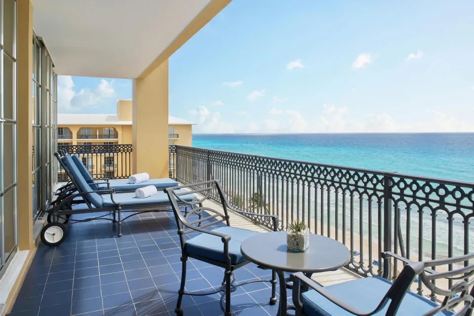 Panoramic Suite balcony with lounge chairs and Caribbean Sea view at Kempinski Hotel Cancún.