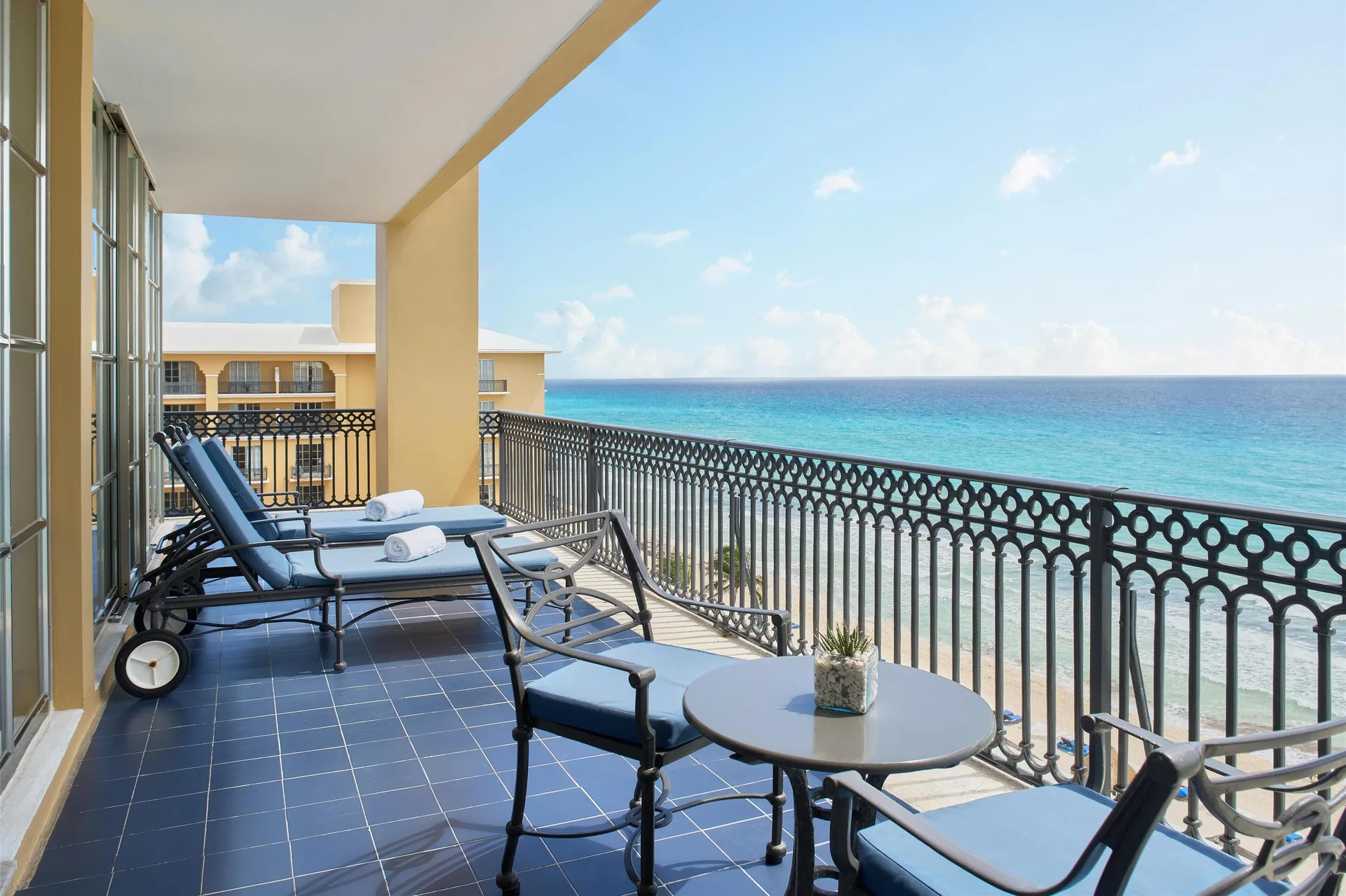 Panoramic Suite balcony with lounge chairs and Caribbean Sea view at Kempinski Hotel Cancún.