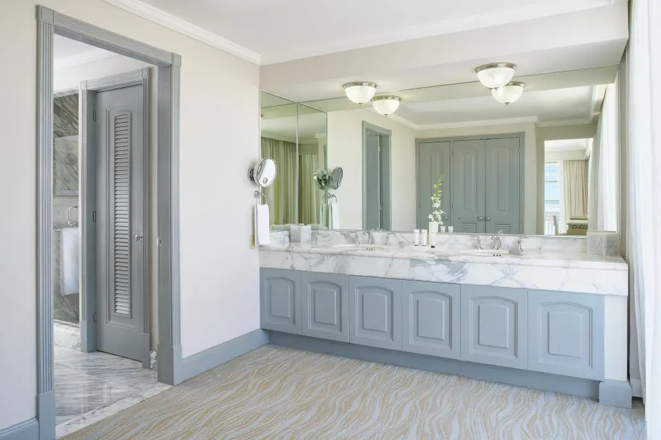 Panoramic Suite vanity with marble counter and double sinks at Kempinski Hotel Cancún.
