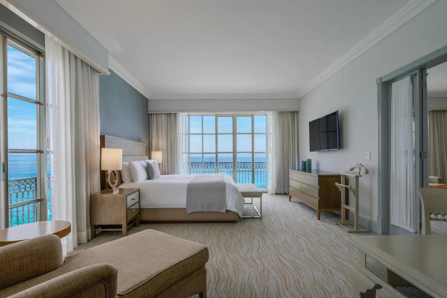 Panoramic Suite bedroom with king bed and ocean view at Kempinski Hotel Cancún.