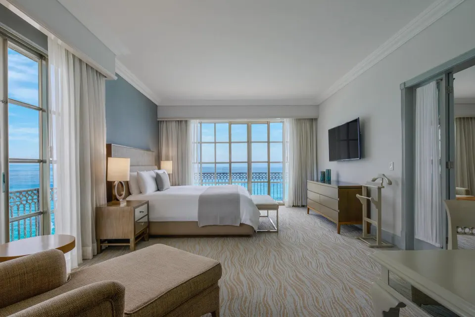 Panoramic Suite bedroom with king bed and ocean view at Kempinski Hotel Cancún.