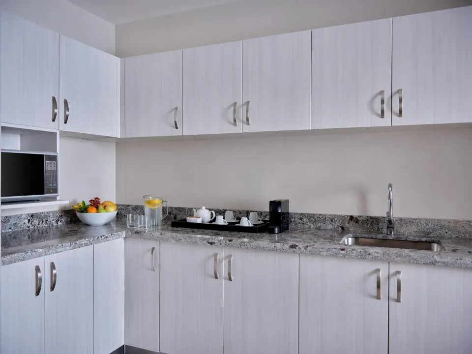 Presidential Suite kitchenette with cabinetry, sink and coffee setup at Kempinski Hotel Cancún.