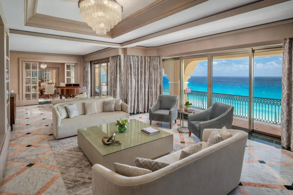 Presidential Suite sitting room with sofas, armchairs and Caribbean view at Kempinski Hotel Cancún.