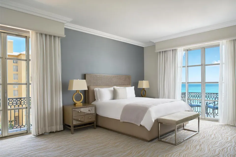 Seafront suite king bedroom with balcony doors and ocean view at Kempinski Hotel Cancún.