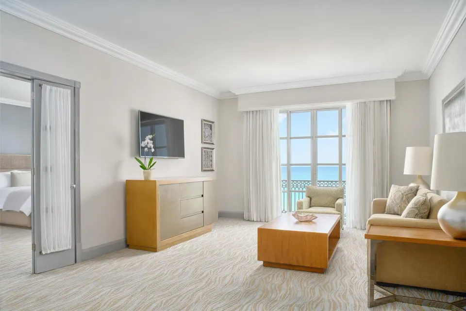 Seafront suite living room with balcony and ocean view at Kempinski Hotel Cancún.