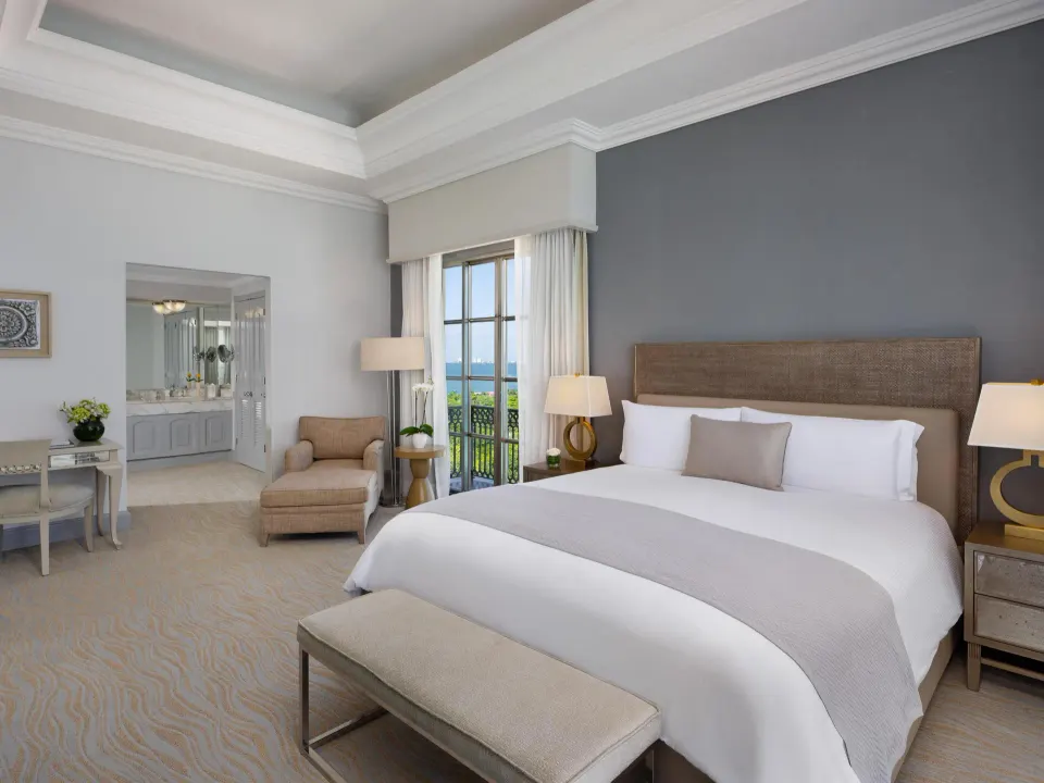Seaside suite king bed with balcony doors and ocean view at Kempinski Hotel Cancún.