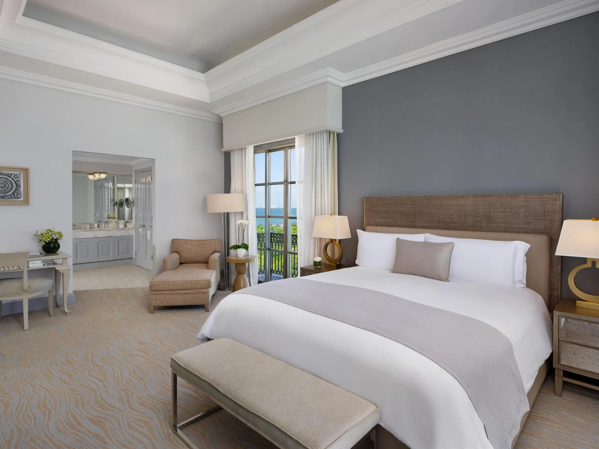 Seaside suite king bed with balcony doors and ocean view at Kempinski Hotel Cancún.